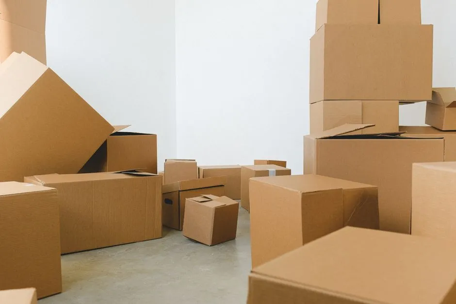 Stacked cardboard moving boxes in an otherwise empty room