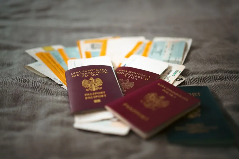 Several passports and travel documents fanned out on a table, prepared for a family reunification application