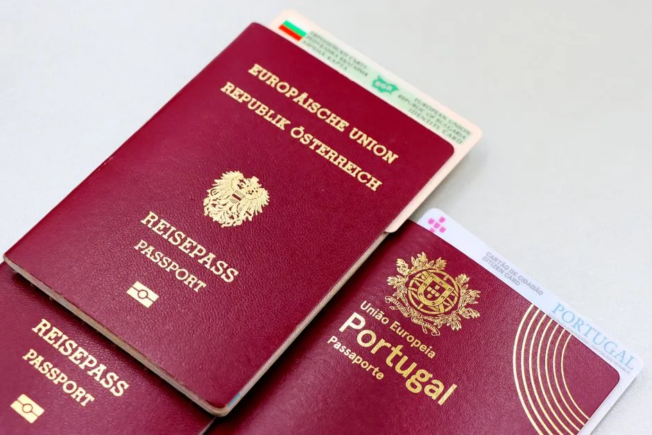 European passports and ID cards fanned out and overlapping on a light surface