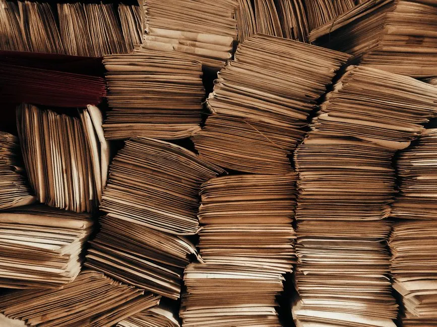 Tall stacks of brown kraft envelopes packed tightly together
