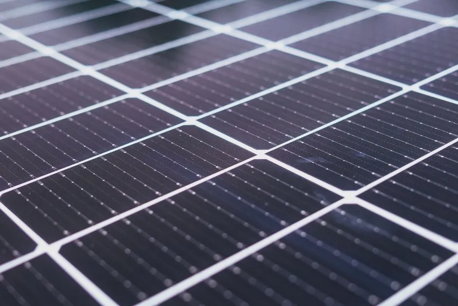 Close-up of a solar panel surface showing its grid of photovoltaic cells, no people, text, or logos visible