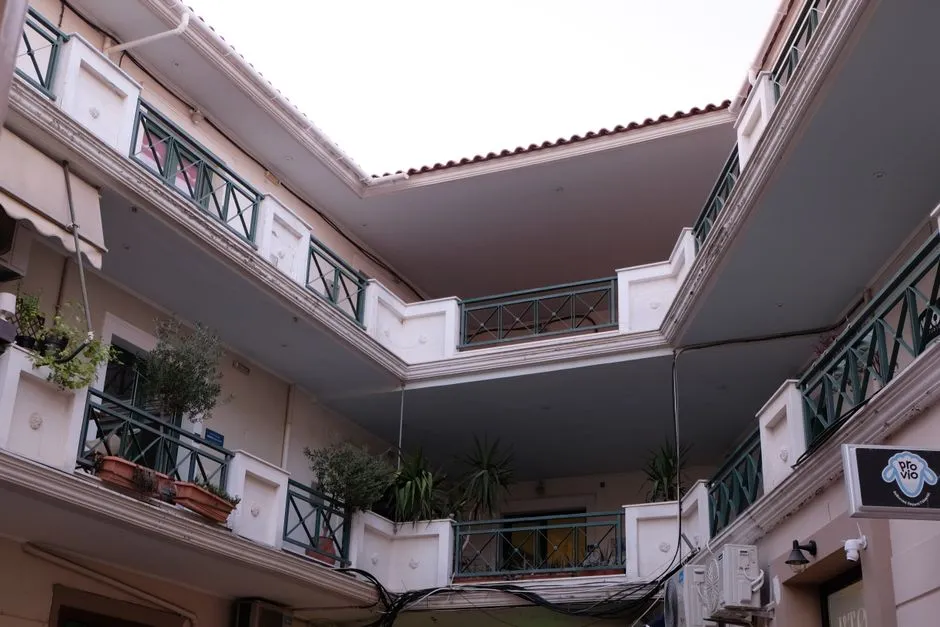 A quiet residential courtyard with apartment balconies during daytime